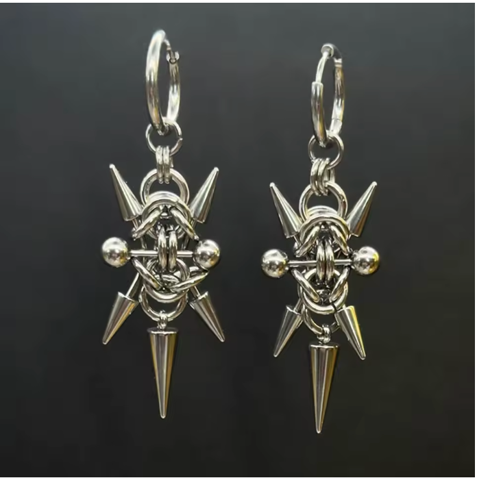Pair of silver spike earrings on a black background