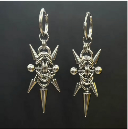 Pair of silver spike earrings on a black background